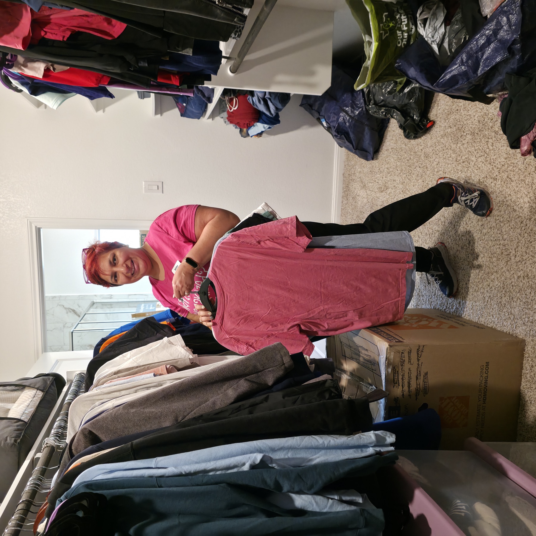 Sahiba, founder of Declutter Bee, sorting donation clothes in a client's closet